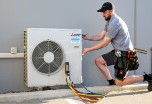 Beattie Air employee repairing Mitsubishi HVAC heat pump in Christchurch