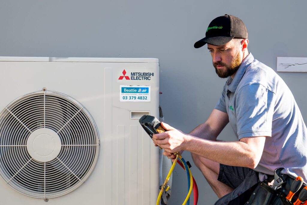 Beattie Air employee servicing on Mitsubishi HVAC heat pump in Christchurch